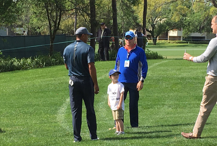 Tiger Woods signed an autograph for a kid who snuck inside the ropes during Tiger’s practice round at the Valspar Championship