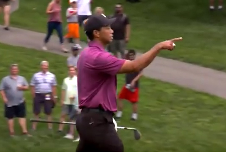 Watch Tiger Woods hole impossible flop shot, flip ball to young fan who greeted him in the rough