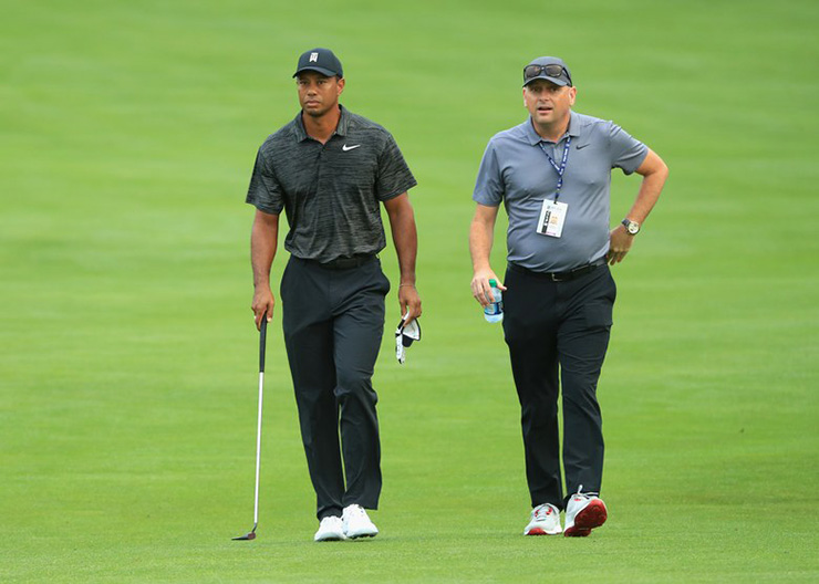 Ever wonder who this guy with Tiger Woods is? Get to know an important cog of Team Tiger