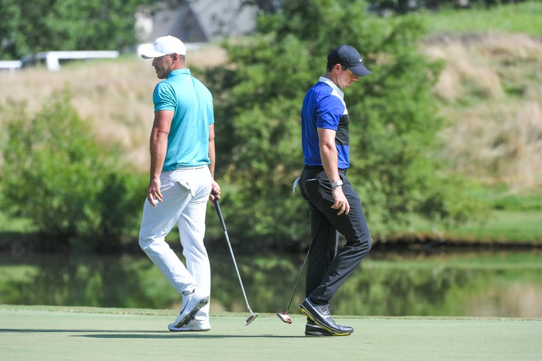 Brooks Koepka and Rory McIlroy, shake hands and come out fighting