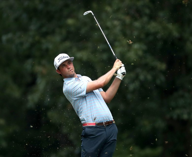 North Carolinian J.T. Poston equals his career low, a 62, to win the Wyndham Championship before a hometown following