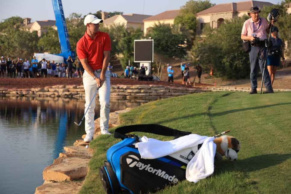Watch Rory McIlroy defy his caddie’s plea and (successfully) play shot off rocks