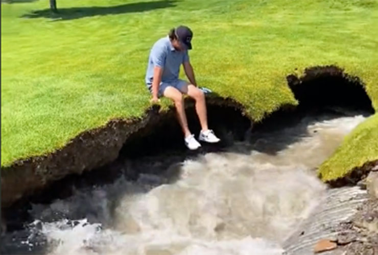 WATCH: Genius golfer seconds from being sucked into sinkhole while posing for video sitting on the edge